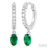 1/8 ctw Petite 5x3 MM Oval Cut Emerald and Round Cut Diamond Precious Fashion Huggies in 10K White Gold